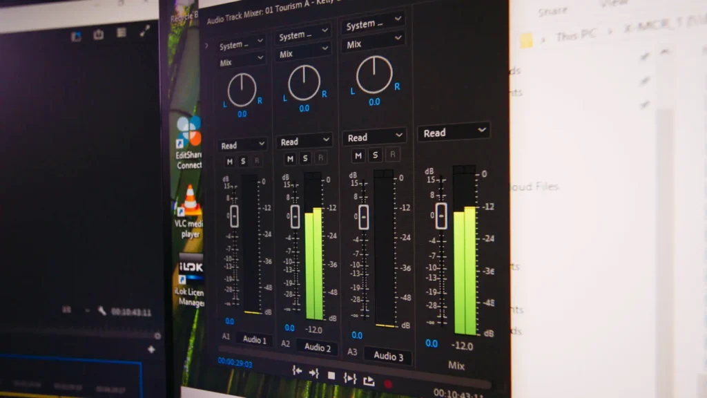 Audio track mixer open in Premiere Pro, levels running on three audio channels